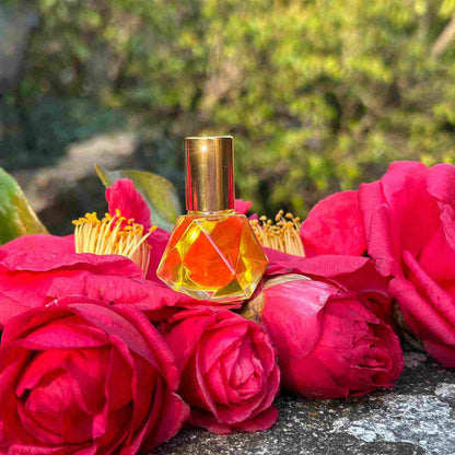 Elegant Flora perfume oil bottle, multifaceted 8ml glass rollon bottle resting on camellia buds