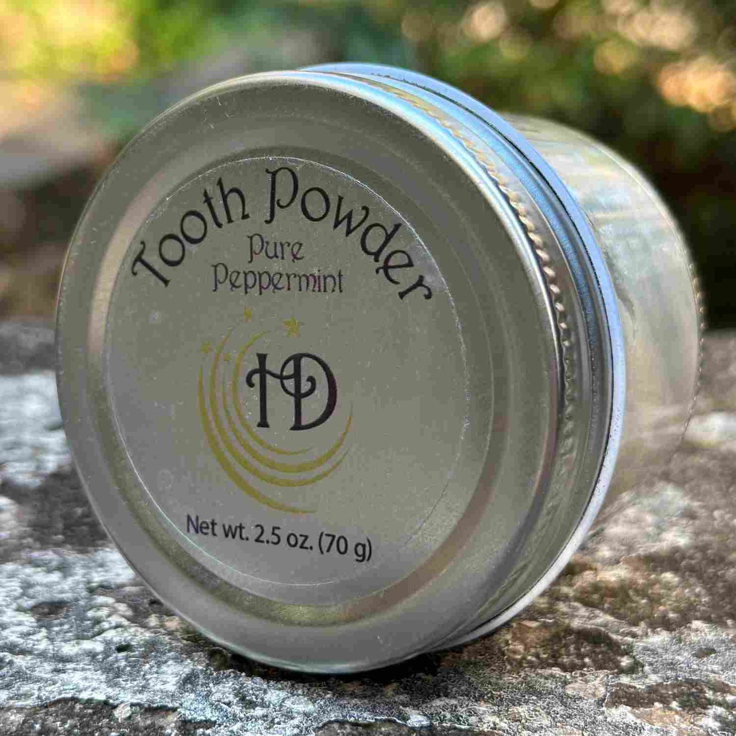 All Natural Mineral Large Pure Peppermint Tooth Powder Jar on Side on Stone Bench