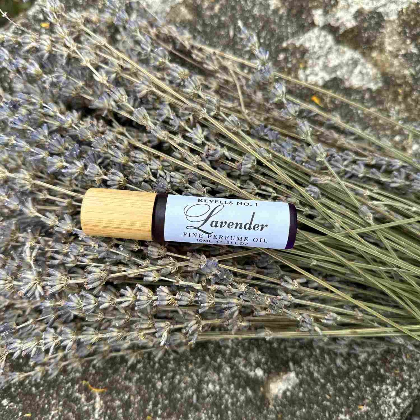 Lavender Perfume Oil bottle on top of dried lavender bunch