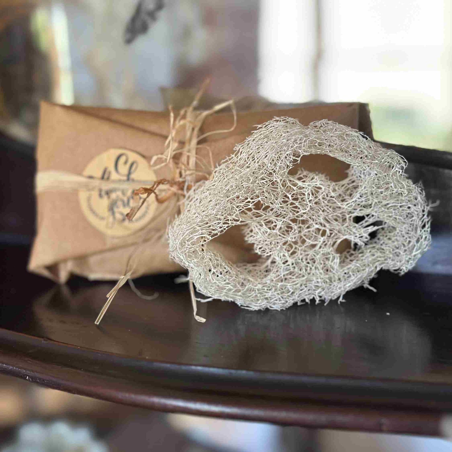 Natural Loofah displayed with beautiful packaging, wrapped in brown paper and tied with raffia