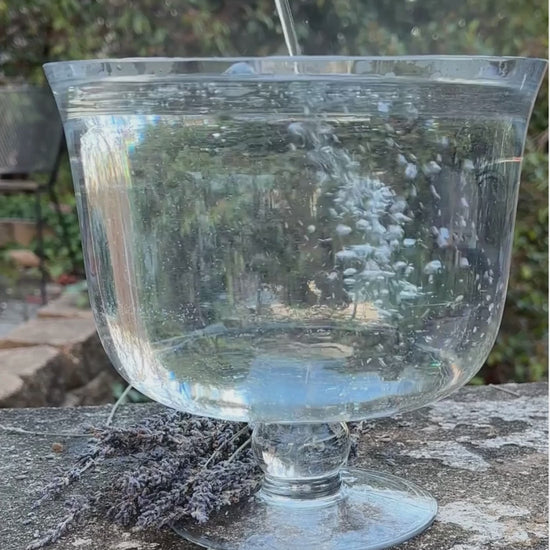 Lavender Bath Bomb Fizzing and Bubbling Over Glass Bowl